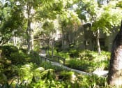 Thumbnail 30 of 30 - a apartment in the middle of a lush green garden