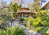 Thumbnail 31 of 42 - A wooden bird aviary surrounded by green plants at The Aspens South Coast, California, 92504