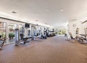 Thumbnail 24 of 42 - A spacious gym with a variety of equipment and a large mirror on the wall at The Aspens South Coast, California, 92504