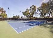 Thumbnail 33 of 42 - Two tennis courts with trees in the background at The Aspens South Coast, California, 92504
