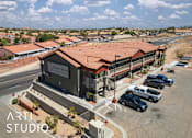 Thumbnail 1 of 8 - A building with the sign "Desert Mess" is surrounded by parked cars.