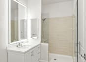 Thumbnail 20 of 35 - a white bathroom with a sink and a shower