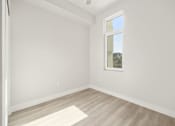 Thumbnail 30 of 35 - an empty room with white walls and a window