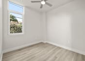 Thumbnail 27 of 35 - an empty room with white walls and a ceiling fan