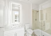 Thumbnail 32 of 35 - a white bathroom with a toilet and a shower