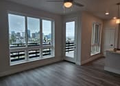 Thumbnail 15 of 88 - A room with a view of the city through large windows.