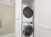 Thumbnail 17 of 35 - a washing machine in a bathroom with a pattern of arms on the wall