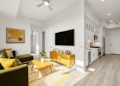 Thumbnail 10 of 35 - a living room with a couch and a yellow table