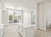Thumbnail 14 of 35 - a large white kitchen with a large window and white cabinets