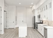 Thumbnail 18 of 35 - a long hallway with white cabinets and white walls and floors and a white counter top