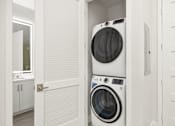 Thumbnail 21 of 35 - a white washer and dryer in a laundry room