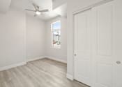 Thumbnail 26 of 35 - an empty bedroom with white walls and a ceiling fan