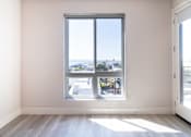 Thumbnail 36 of 88 - A room with a large window overlooking a street.