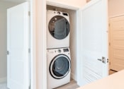 Thumbnail 50 of 88 - A white washing machine and dryer are built into a wall in a laundry room.