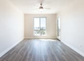 Thumbnail 45 of 88 - A room with a ceiling fan and a large window.