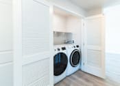 Thumbnail 13 of 88 - A laundry room with a washer and dryer in it.