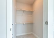 Thumbnail 62 of 88 - A white closet with shelves and a door.