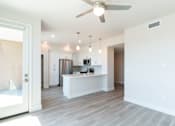 Thumbnail 63 of 88 - A modern kitchen with a bar area and a ceiling fan.