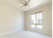 Thumbnail 75 of 88 - A room with a ceiling fan and a window.