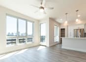 Thumbnail 73 of 88 - A spacious kitchen and living room with a large window overlooking the city.