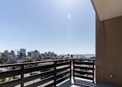 Thumbnail 66 of 88 - A balcony overlooks a cityscape on a sunny day.