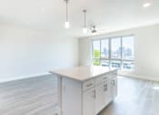 Thumbnail 31 of 88 - A kitchen with white cabinets and a large island.