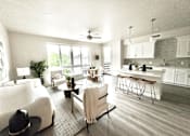 Thumbnail 5 of 88 - A modern open plan living and kitchen area with a dining table and chairs.