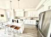 Thumbnail 9 of 88 - A kitchen with a white island and stainless steel appliances.