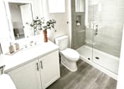 Thumbnail 11 of 88 - A bathroom with a toilet, sink, and mirror.