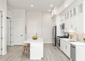 Thumbnail 4 of 35 - a white kitchen with a white counter top and a stainless steel