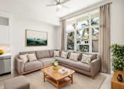 Thumbnail 5 of 35 - a living room with a couch and a coffee table