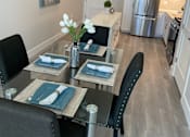 Thumbnail 7 of 35 - a kitchen and dining room with a glass table and chairs