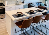 Thumbnail 2 of 35 - a kitchen and living room with a table and chairs