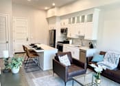 Thumbnail 1 of 35 - a kitchen and living room with a table and chairs