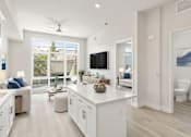 Thumbnail 9 of 35 - a white living room with a kitchen and a large window