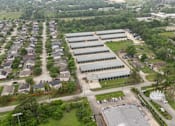 Thumbnail 5 of 11 - An aerial view of the Houston Premium Storage facility showing multiple buildings and surrounding area.