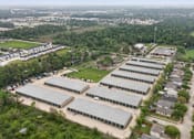 Thumbnail 2 of 11 - An aerial view of the Houston Premium Storage facility showing multiple buildings and exterior parking..