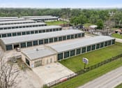 Thumbnail 4 of 11 - An aerial view of the Houston Premium Storage facility showing multiple buildings and office entrance..