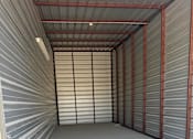 Thumbnail 8 of 11 - The inside of a 14x40 storage unit with clean concrete floor and metal walls.