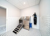 Thumbnail 8 of 8 - a kitchen with a sink and apron in a white room with a door