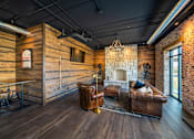 Thumbnail 6 of 8 - a living room with leather furniture and a stone fireplace