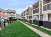 Thumbnail 3 of 35 - Building area view1 at Royal Wildewood Manor Apartments, Texas