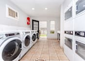 Thumbnail 15 of 35 - Laundry room at Royal Wildewood Manor Apartments, Clute, TX