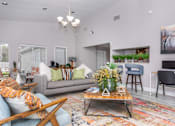 Thumbnail 18 of 35 - Living room with couch and tv and open kitchenat Royal Wildewood Manor Apartments, Clute, Texas