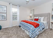 Thumbnail 31 of 35 - Bedroom with cozy bed at Royal Wildewood Manor Apartments, Clute, Texas