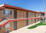 Thumbnail 12 of 20 - A row of apartment buildings with balconies and a red roof.