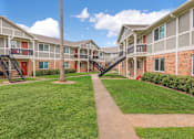Thumbnail 4 of 26 - Lush Green Landscape at Castlewood Apartments, Clute, Texas