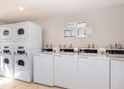 Thumbnail 10 of 20 - a group of washers and dryers in a laundromat with a row
