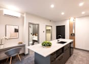 Thumbnail 21 of 22 - A modern kitchen with a large island and a dining area.