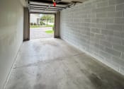 Thumbnail 13 of 27 - Interior of 1-car garage looking out towards driveway